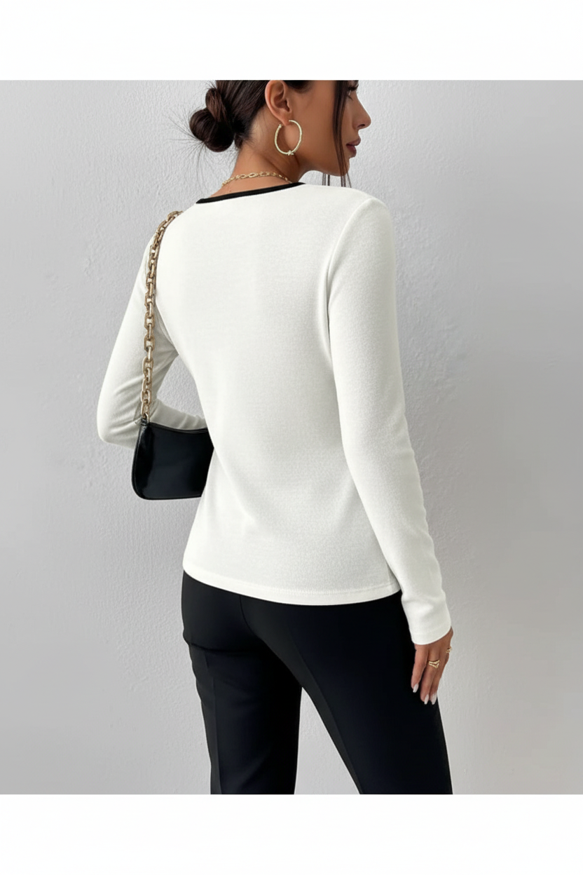 White long sleeve top with black contrast trim back angle
